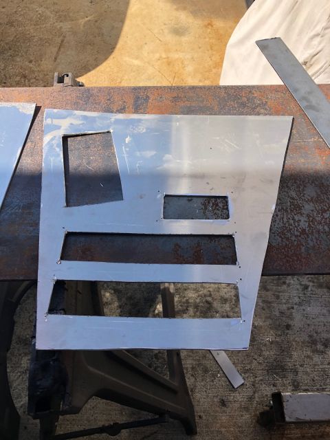 1992 Jeep Wrangler - A custom-cut sheet metal panel with multiple rectangular cutouts is shown on a workbench. The panel appears to be a modification or part fo…