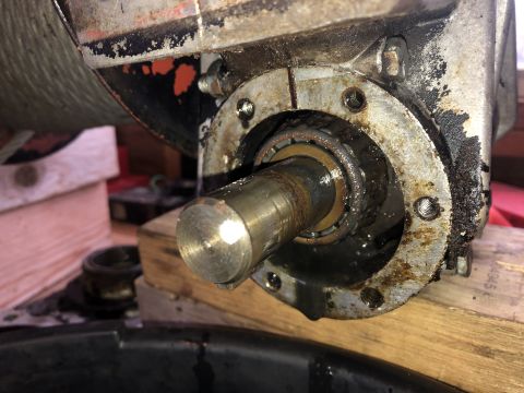 1980 Ford Bronco - A close-up view of a heavily greased and corroded mechanical component, likely part of a vehicle's drivetrain, showing a metal shaft extend…