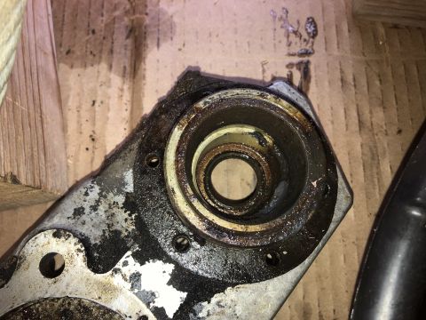 1980 Ford Bronco - A heavily greased and corroded metal component, likely a part of a vehicle's drivetrain or engine, is shown in close-up. The part features…