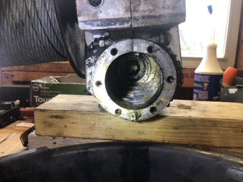 1980 Ford Bronco - A close-up view of the internal gears of a vehicle's winch mechanism, showing grease and some fluid within the housing. The winch drum and…