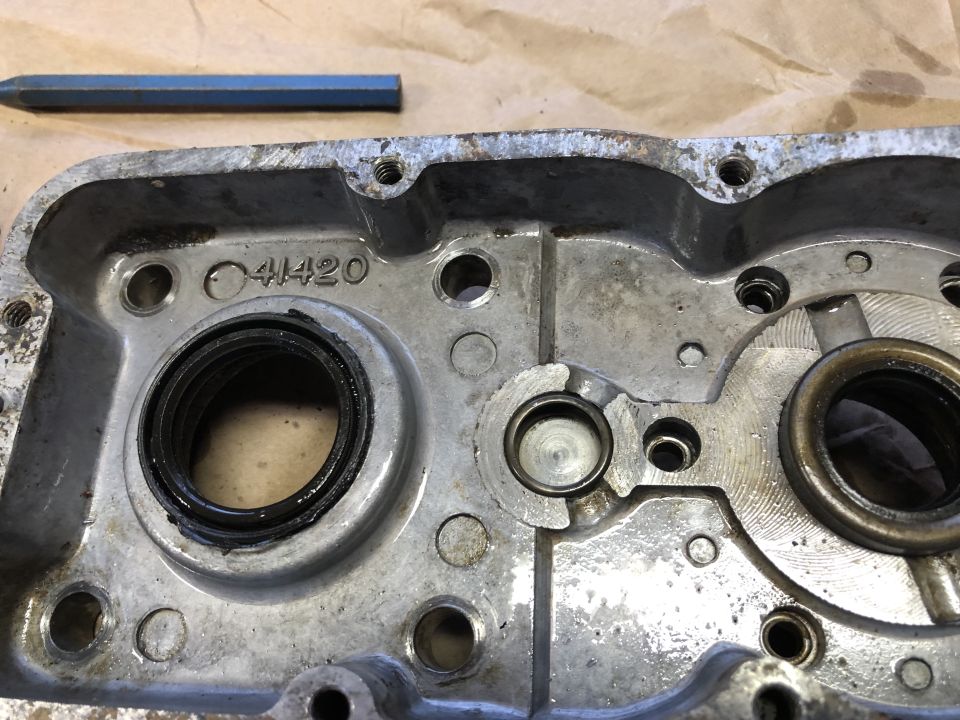 Metal engine part with a circular seal and a number stamped '41420'
