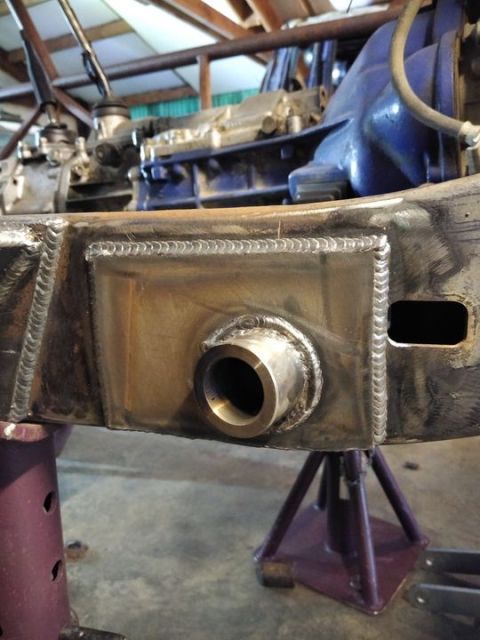 1985 Toyota Hilux - Custom fabrication work on a vehicle's chassis, showing a reinforced section with a protruding pipe.