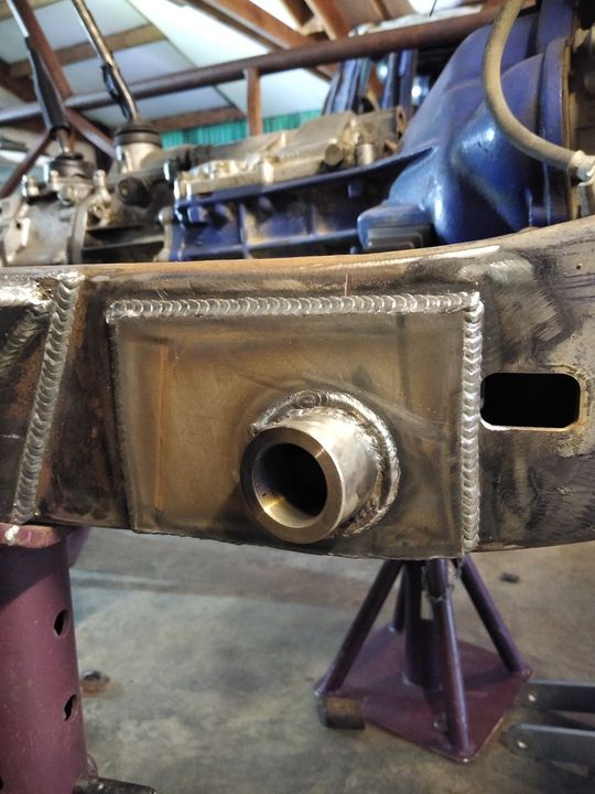 Close-up of a vehicle frame with a newly welded metal tube fitting