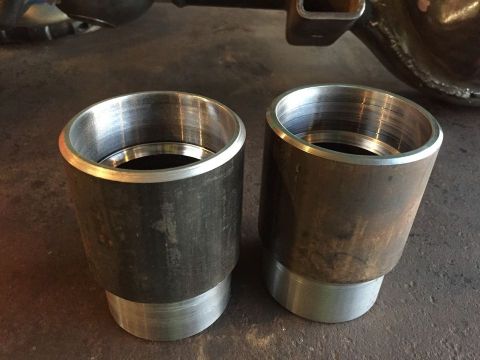 1985 Toyota Hilux - Two metal exhaust tips are shown close-up, with a portion of a vehicle's rear axle visible in the background.