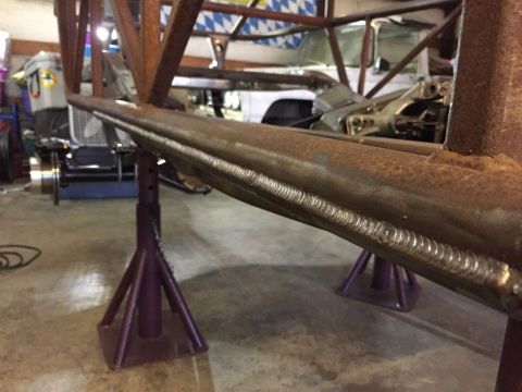 1985 Toyota Hilux - Metal frame section undergoing fabrication, supported by jack stands.