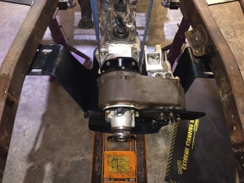 1985 Toyota Hilux - Close-up view of a vehicle's transmission and transfer case assembly, supported by jack stands.