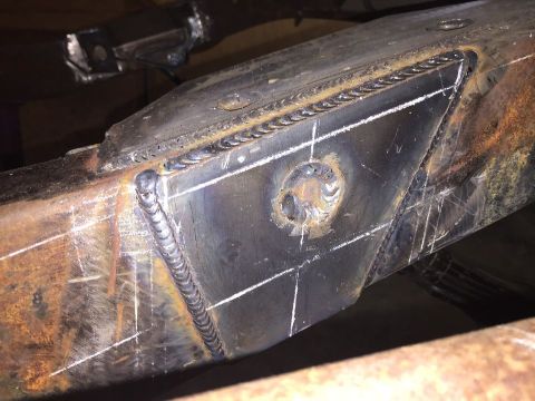 1985 Toyota Hilux - Close-up of a heavily modified and welded metal frame, showing signs of rust and chalk markings.