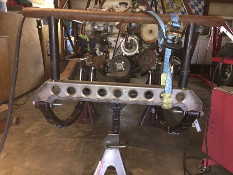 1985 Toyota Hilux - A heavily modified vehicle frame with a large engine mounted on jack stands. The suspension components, including leaf springs, are visible…