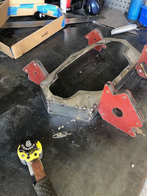 1992 Jeep Wrangler - Custom metal part being fabricated on a workbench with welding clamps.