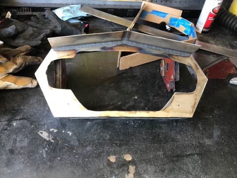 1992 Jeep Wrangler - Custom-fabricated metal frame, likely a radiator core support or grille surround, sitting on a garage floor with work gloves nearby.
