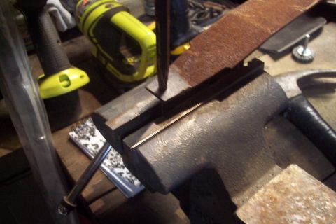 1995 Ford Bronco - A workbench scene shows a vise holding a metal part, with a hammer and power tools in the background.