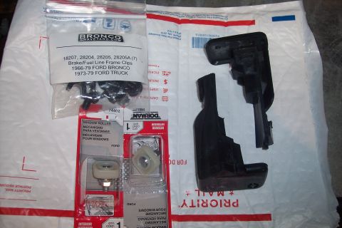 1995 Ford Bronco - Parts for 1966-79 Ford Bronco and 1973-79 Ford Truck are laid out on packaging.