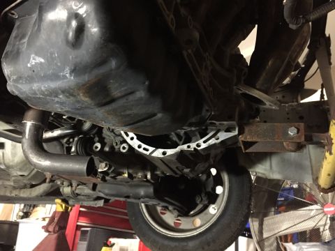 1993 Mercury Tracer - Undercarriage view of a vehicle, showing engine components and a wheel.