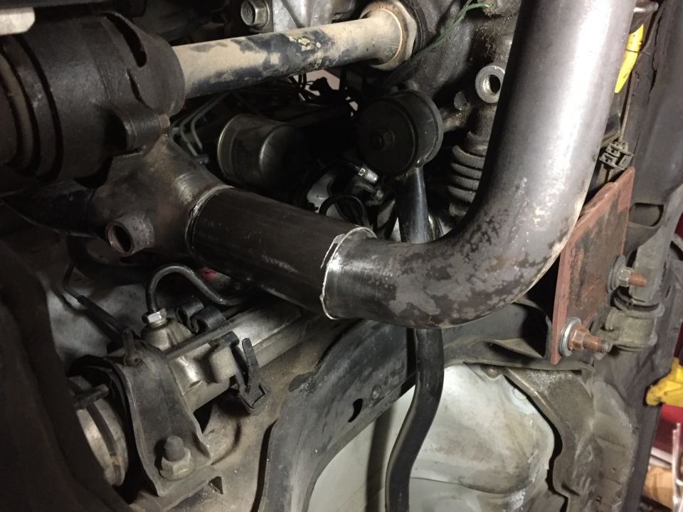Exhaust pipe modification with visible Supermotors.net logo