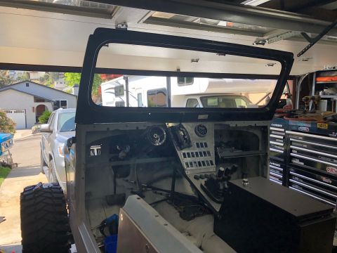 1992 Jeep Wrangler - The interior of a 1992 Jeep Wrangler is visible, with parts of the dashboard removed for work.