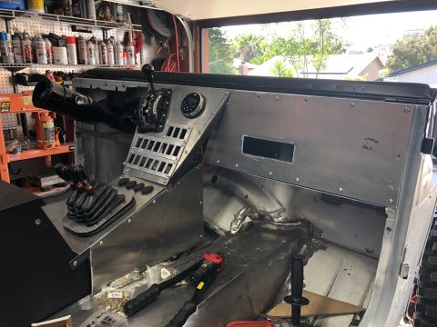 1992 Jeep Wrangler - Custom metal dash and shifter console in a Jeep interior, with tools visible on the floor.