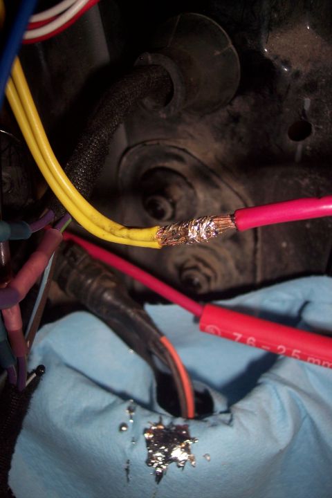 1995 Ford Bronco - Close-up of electrical wiring repair with twisted connections and tape.