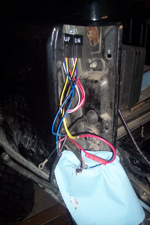 1995 Ford Bronco - Close-up of a vehicle's wiring harness with relays, showing exposed wires and connections.