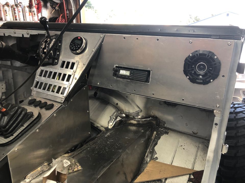 Custom aluminum dash with shifter, radio, and speaker. Floor is bare metal