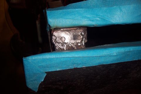 1995 Ford Bronco - Metal bracket with welds, taped off for repair or modification.