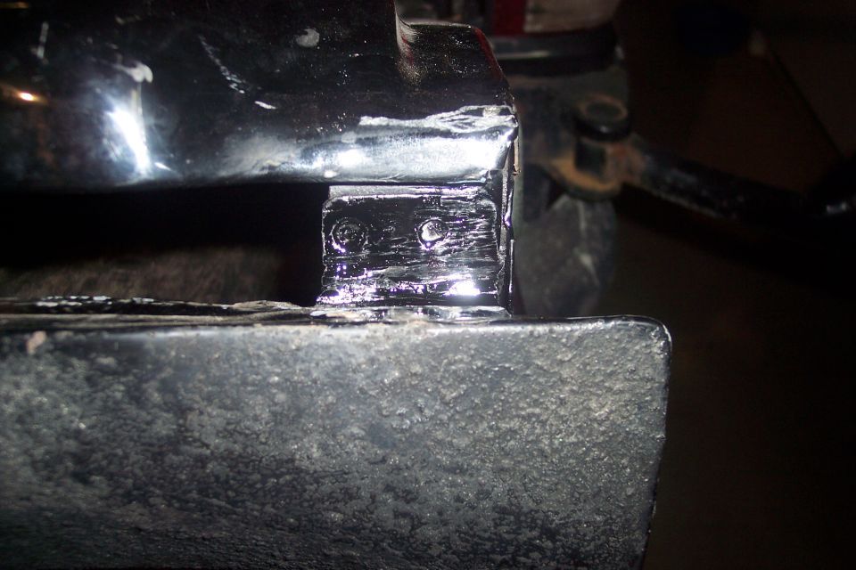 Close-up of a patch weld on a vehicle frame