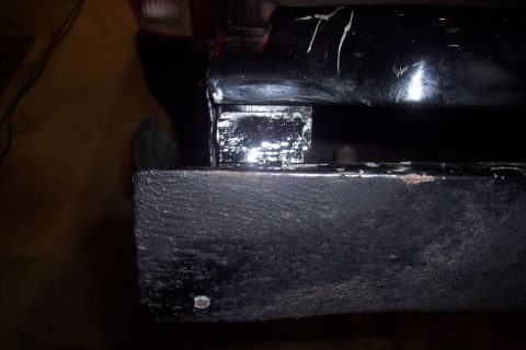 1995 Ford Bronco - Detail of a vehicle frame part, possibly a bumper mount or suspension component.