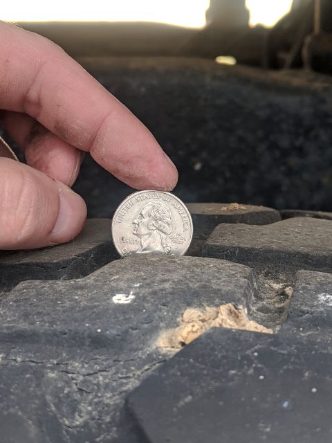 1996 Ford Bronco - Measuring tire tread depth with a quarter.