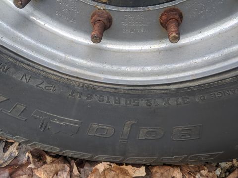 1996 Ford Bronco - This image shows a close-up of a BFGoodrich Baja tire and wheel assembly, with visible text indicating tire size and pressure.