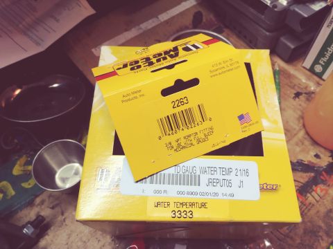 1996 Ford Bronco - A yellow Auto Meter parts box with a smaller yellow box on top. The smaller box displays a part number 2263 and text indicating it is a 3/8…