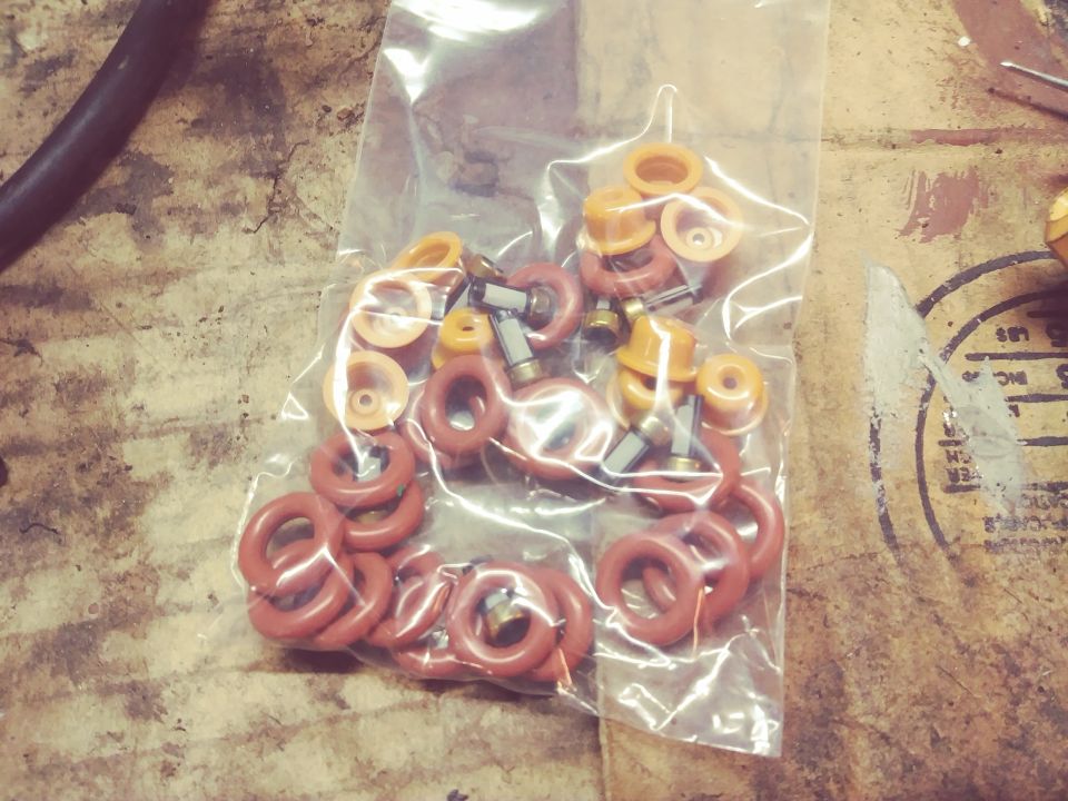 Bag of assorted red and orange O-rings and small metal parts.