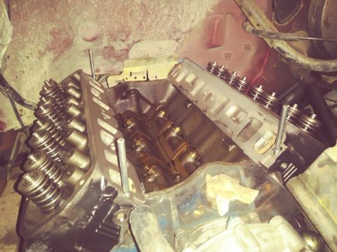 1996 Ford Bronco - A close-up view of the engine bay of a Ford Bronco, showing the cylinder heads and valve train components.