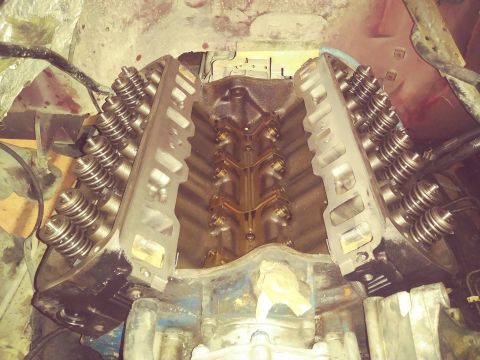 1996 Ford Bronco - A close-up view of the engine block and cylinder heads of a V8 engine, with the intake manifold removed. The valve springs and rocker arms…