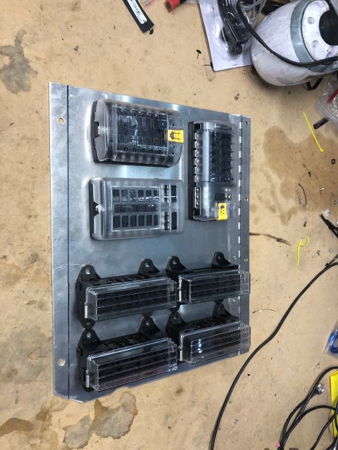 1992 Jeep Wrangler - A custom-built electrical fuse and relay panel is mounted on a brushed aluminum plate. The panel features multiple fuse blocks and relay so…