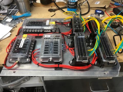 1992 Jeep Wrangler - A custom-built electrical fuse block system is mounted on a metal panel, featuring multiple fuse boxes connected by red, yellow, and green…