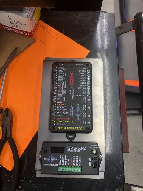 1992 Jeep Wrangler - Two Dakota Digital electronic control units are mounted on a metal plate. The upper unit is a HDX control box, and the lower unit is a GPS-…