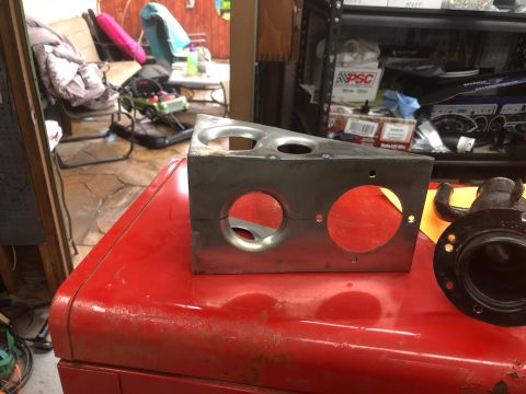 1992 Jeep Wrangler - A custom-fabricated metal bracket with three circular cutouts sits on top of a red metal surface, possibly a toolbox. To the right of the b…