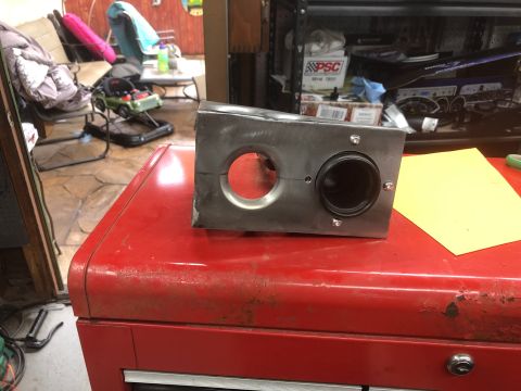 1992 Jeep Wrangler - A custom metal part with two circular openings is placed on top of a red metal toolbox. The part appears to be a component for a vehicle mo…