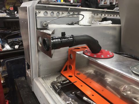 1992 Jeep Wrangler - A close-up view shows a custom fuel tank installation with a black hose connected to a red fuel filler cap on a metal tank. The surrounding…