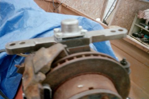1979 Ford Bronco - Close-up of a vehicle's steering linkage and brake system components.