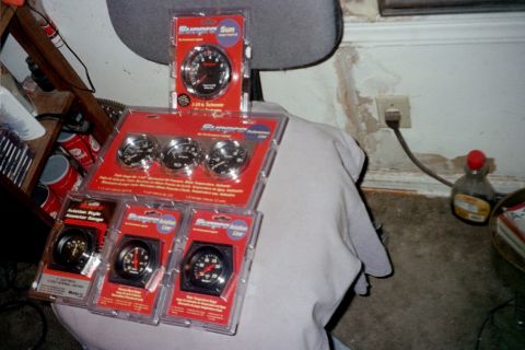 1979 Ford Bronco - A collection of Sunpro gauges, including a tachometer and other assorted gauges, are displayed in their retail packaging.
