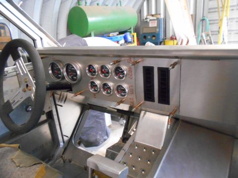 1992 Ford Bronco - The interior of a custom vehicle build shows a dashboard with multiple gauges, a steering wheel, and ventilation slots. The vehicle appears…