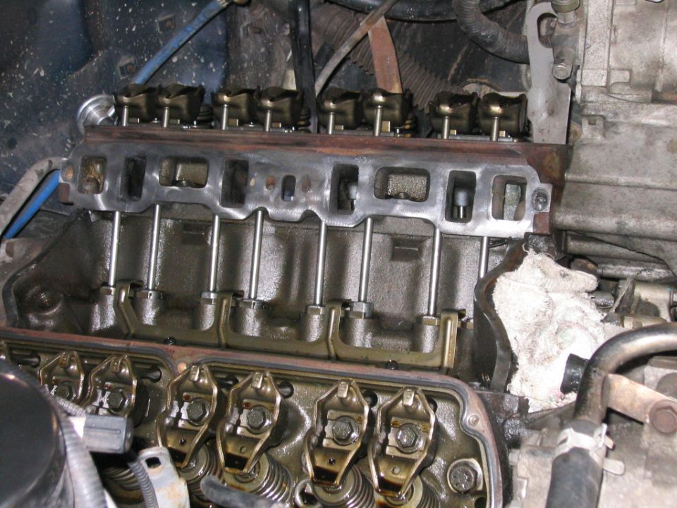Close-up of V8 cylinder head with rocker arms, pushrods and open lifter valley