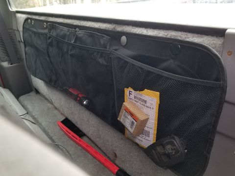 1997 Ford F-250 - This cheap pocket is sold as over-the-seat storage with a bunch of loose strings to tie it on, but this seemed like a much better way to ha…