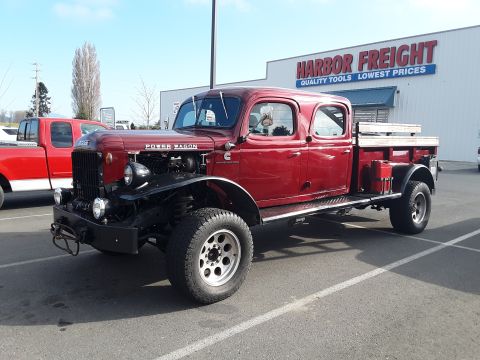 1985 Toyota Hilux - A red four-door pickup truck, identified as a Power Wagon, is parked in a lot with a Harbor Freight store in the background.