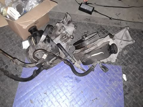 1994 Ford Bronco - These power steering pumps are laid out on a mat, possibly for repair or replacement.