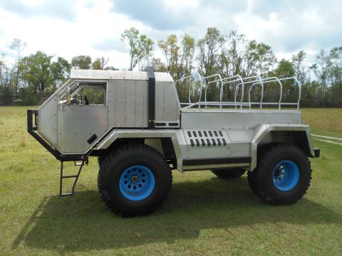 1992 Ford Bronco - This custom vehicle has a unique design with large tires and a roll cage in the rear bed.