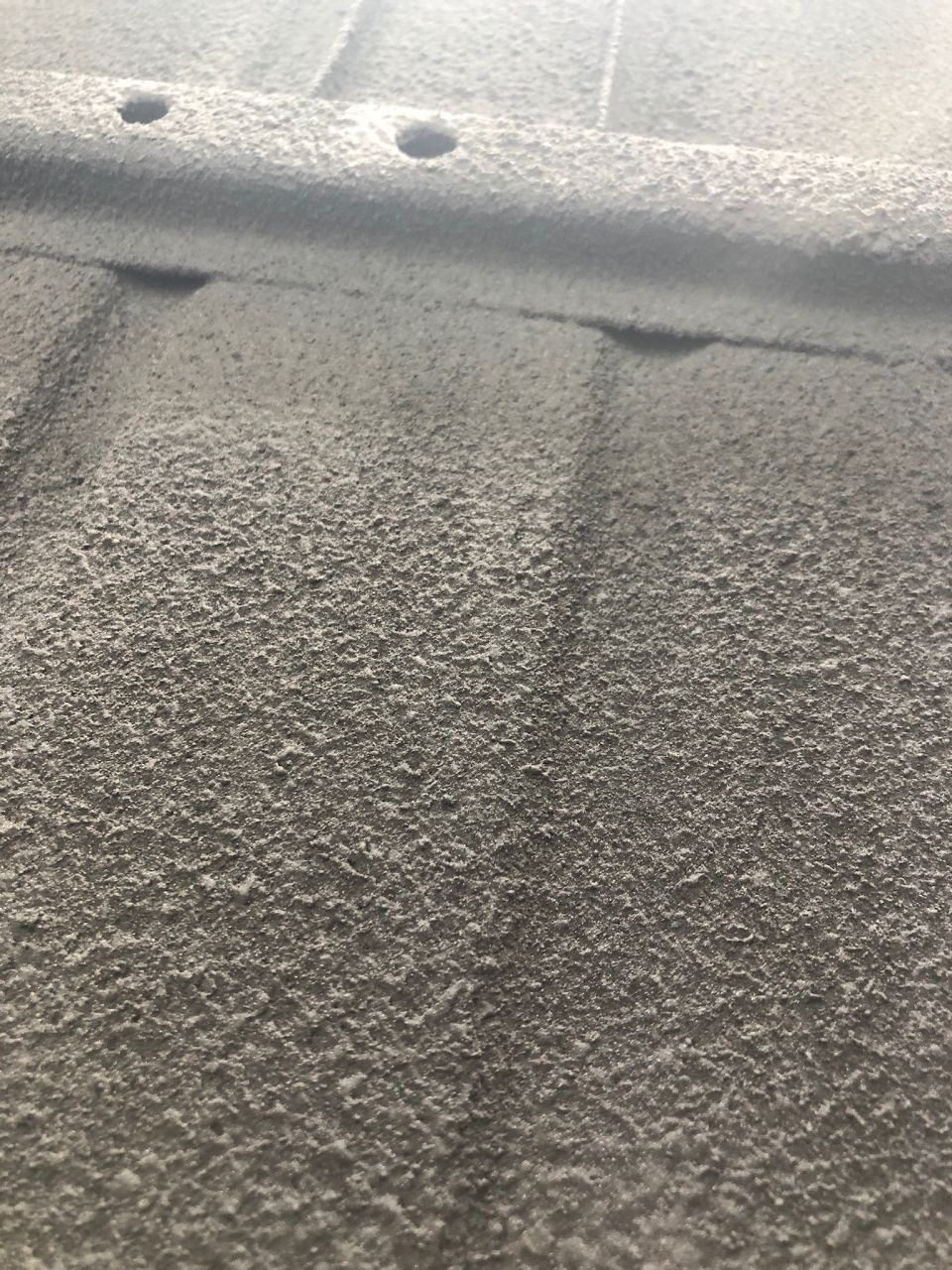 Close-up of textured underbody coating with visible pores and some raised areas