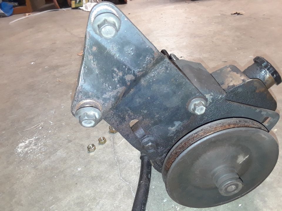 Power steering pump with pulley and mounting bracket