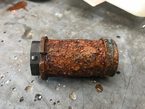 1979 Ford Bronco - This heavily rusted metal pipe fitting shows significant corrosion and wear.