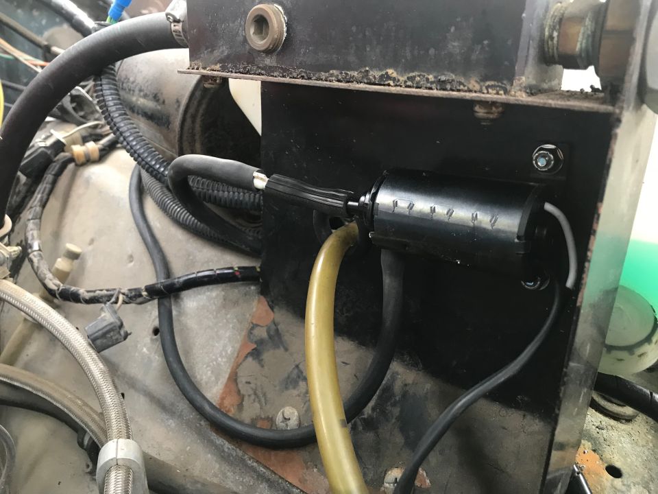 Windshield washer pump with yellow hose and black wires